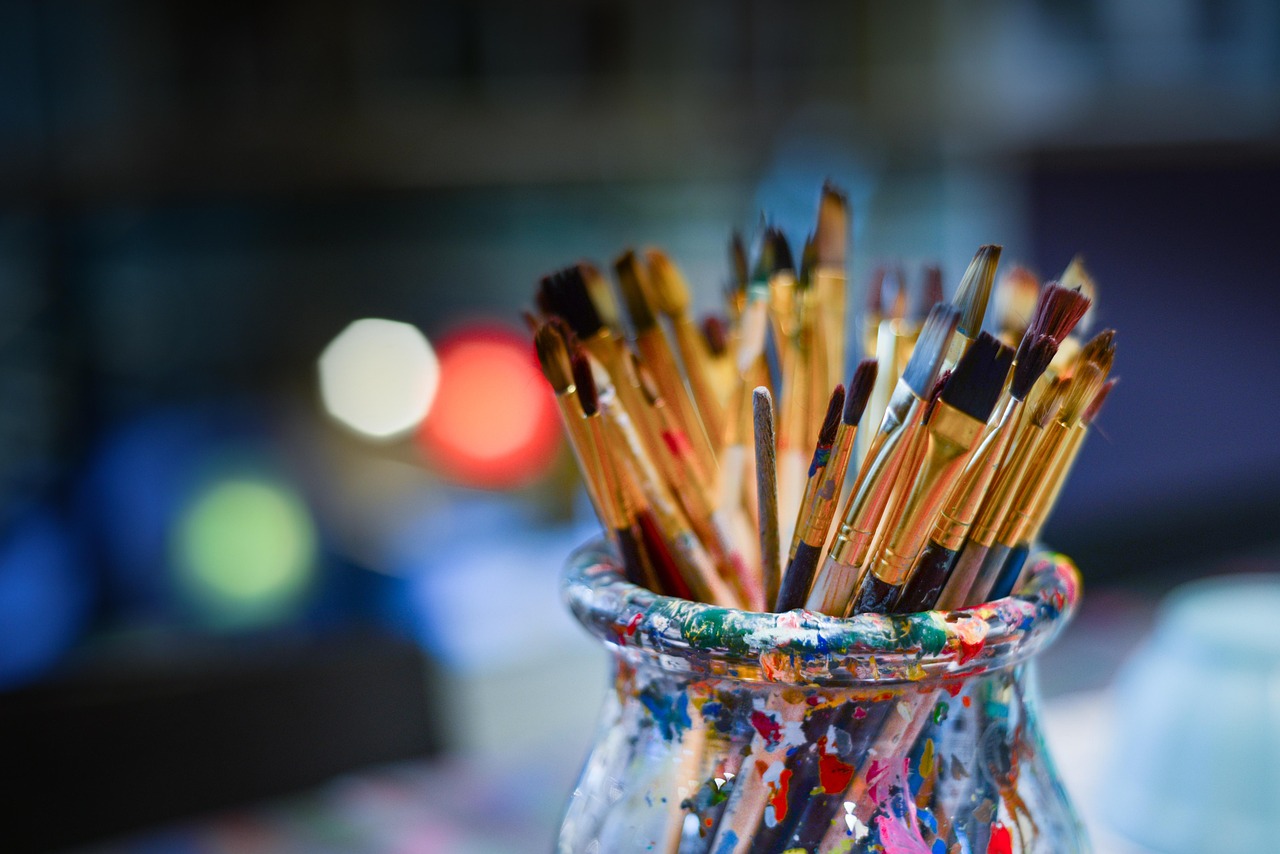 Brushes and mixing bowls laid out on a work table